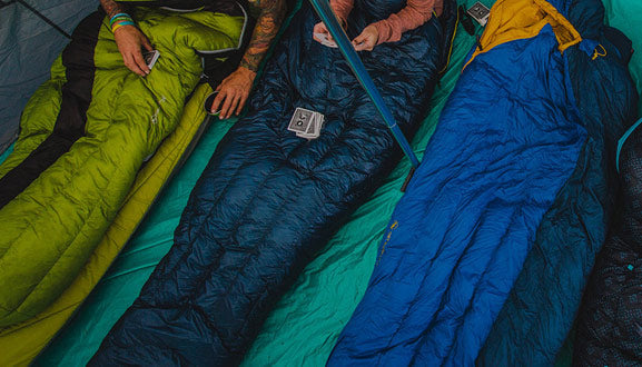 Sleepings bags in a row inside a tent